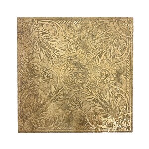 May include: Square, gold-colored decorative tile with an ornate, embossed floral and scroll pattern. The tile has a textured surface and a weathered appearance, suggesting an antique or vintage style. The design features a central medallion and corner accents.