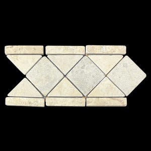 May include: A decorative tile arrangement with a repeating pattern of diamond and triangle shapes. The tiles are a light beige colour, with a slightly textured surface. Suitable for flooring or wall applications.
