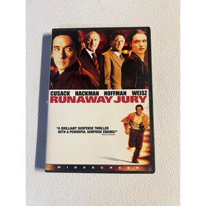 May include: DVD of the movie "Runaway Jury" featuring Cusack, Hackman, Hoffman, and Weisz. The cover has a group of actors and a running man. The text reads "A brilliant suspense thriller with a powerful surprise ending!"