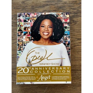 May include: The Oprah Winfrey Show 20th Anniversary Collection DVD set. The cover features a photo of Oprah Winfrey, with the show's logo in gold script. The DVD set is for the benefit of Angel Network.