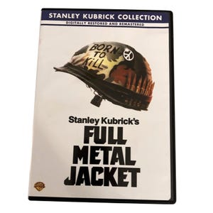 May include: DVD of Stanley Kubrick's "Full Metal Jacket." The cover shows a military helmet with "Born to Kill" and a peace symbol. The DVD case is black with white text.