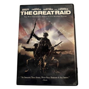 May include: DVD of the film "The Great Raid" featuring Benjamin Bratt, James Franco, Connie Nielsen, and Joseph Fiennes. The cover shows soldiers with rifles against a backdrop of the American flag. The text reads "The Most Triumphant Rescue in U.S. Military History."