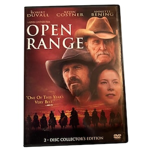 May include: DVD case for the film "Open Range" featuring Robert Duvall, Kevin Costner, and Annette Bening. The cover has a red and brown gradient background with images of the actors and cowboys on horseback. The text "Open Range" is prominently displayed.
