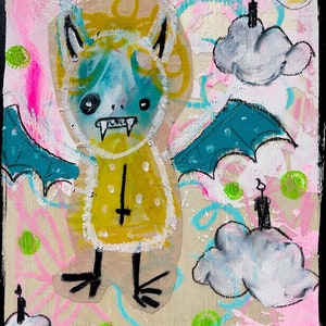 May include: A colorful painting of a cartoon bat with yellow, blue, and white colors. The bat has a cross on its chest and is flying in a pink and green sky with clouds. The painting is signed "Lana Guerra 2021" in the bottom right corner.