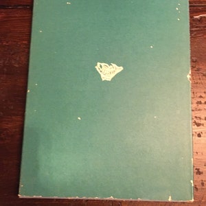 May include: A green book with a white logo on the front cover.