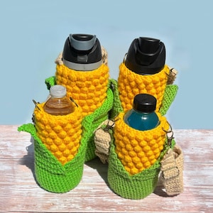 May include: Four water bottles in crocheted corn on the cob covers. The covers are yellow and green with a brown strap.