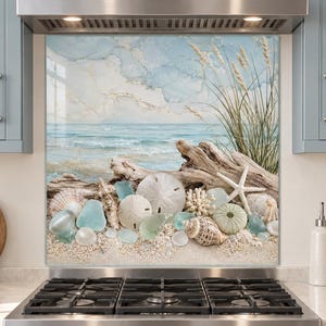 May include: A rectangular kitchen backsplash panel featuring a coastal scene with a sandy beach, driftwood, various seashells, sea urchins, a starfish, and tall beach grass against a light blue and white sky with soft clouds and gold accents.
