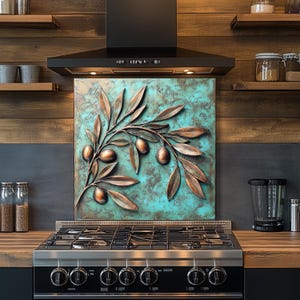 Pu&ograve; includere: Un ramo di ulivo color rame con olive e foglie &egrave; montato su un pannello quadrato turchese e bronzo. L'opera d'arte &egrave; esposta sopra un fornello a gas in acciaio inossidabile in una cucina. La cucina ha mensole in legno e una cappa nera.