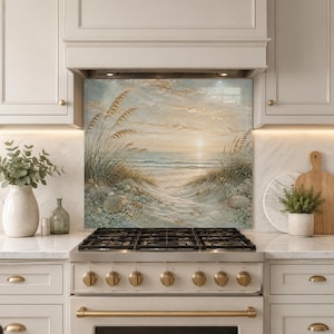 May include: A rectangular kitchen backsplash panel featuring a coastal landscape painting of a sandy beach with tall dune grasses, seashells, and a calm ocean under a soft sunrise sky with muted beige, blue, and white colour tones.