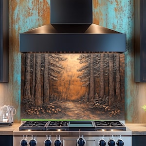 May include: A copper-colored kitchen backsplash featuring a detailed forest scene with tall trees and a path. The backsplash is installed behind a stainless steel stove and beneath a black range hood.