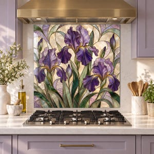 May include: A square kitchen backsplash panel featuring a stained glass style illustration of purple iris flowers with green leaves and stems. The design includes three large blooming irises and several buds against a light, textured background.