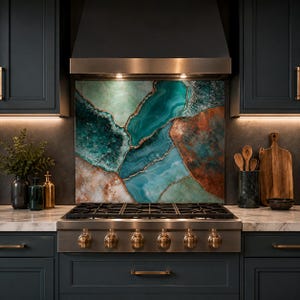 May include: A kitchen backsplash panel featuring a large-scale print of teal, turquoise, and copper-toned agate stone slices with gold-colored veining, positioned behind a stainless steel gas range with six burners and metallic knobs.