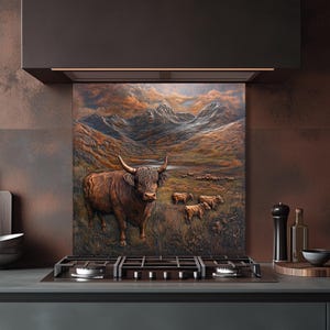May include: A decorative kitchen backsplash featuring a detailed relief of a Highland cow in a mountainous landscape. The artwork is predominantly brown and tan, with a herd of cows in the background. The backsplash is installed above a gas stovetop.