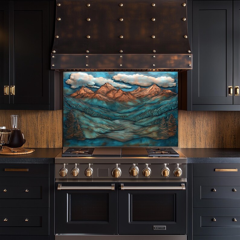 May include: A kitchen range with a decorative mountain scene splashback. The range has a stainless steel finish with brass accents. The cabinets are black with brass hardware. The range hood is bronze with rivets.