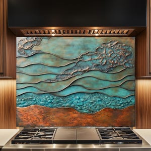 May include: A custom range hood backsplash with a textured, abstract design. The artwork features layers of turquoise, copper, and bronze tones, evoking a landscape or seascape. The backsplash is installed above a stainless steel gas range.
