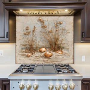May include: A kitchen backsplash depicting a beach scene with seashells and grasses. The artwork has a textured finish with beige, brown, and tan tones. The backsplash is installed above a stainless steel gas range.