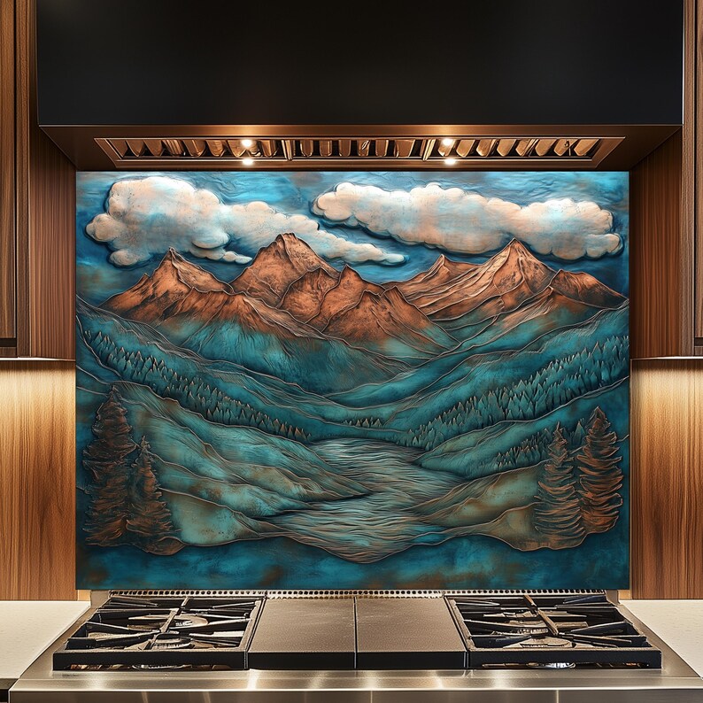 May include: A kitchen backsplash with a mountain scene. The relief artwork depicts mountains in copper and teal, with white clouds against a blue sky. The design includes a forest and a river. The backsplash is installed above a gas hob.