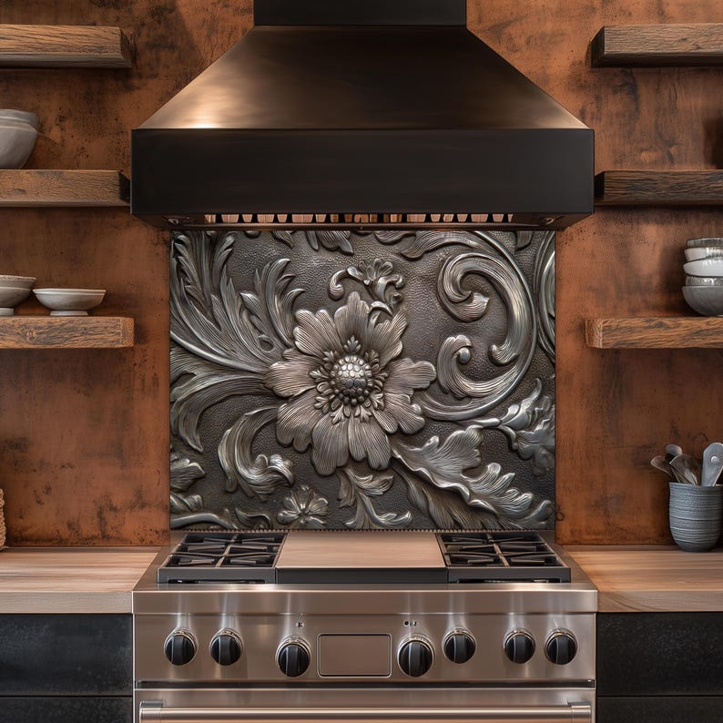 May include: A stainless steel gas range with a decorative backsplash featuring a large floral design. The backsplash is made of a dark metal with a raised, detailed pattern. The kitchen also includes wooden shelves and a range hood.