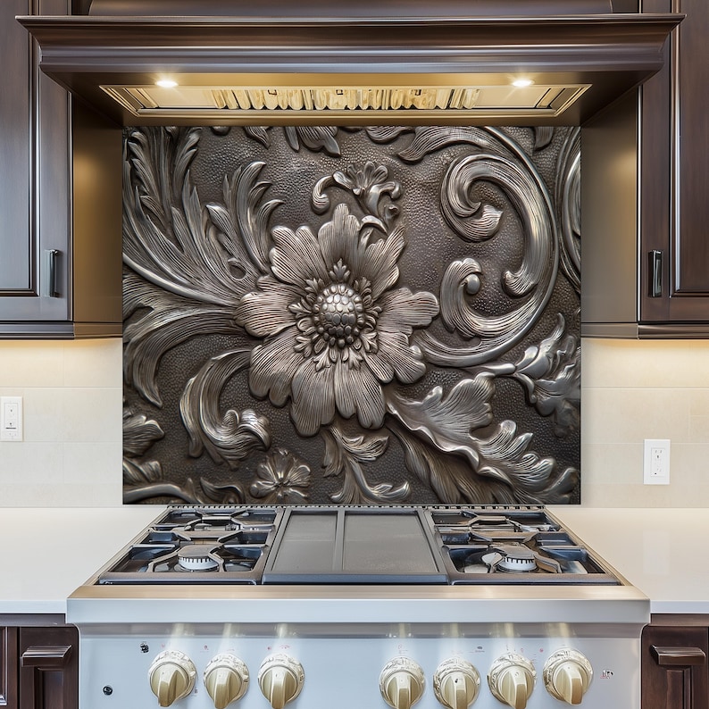 May include: A decorative kitchen backsplash with a detailed floral design. The backsplash features a large, central flower surrounded by ornate leaves and swirling patterns. The color is a metallic silver against a dark background, creating a striking contrast.