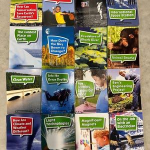 May include: A collection of children's educational books with various titles, including "How Do Forces Affect Motion?", "To the Moon", and "Animal Smarts". The covers feature colorful illustrations and photographs related to science and nature.
