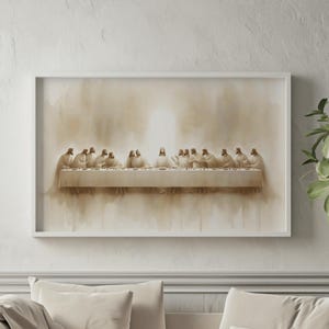May include: A framed print of the Last Supper, featuring Jesus and his disciples at a long table. The artwork is rendered in sepia tones, with a soft, painterly style. The frame is white, and the overall aesthetic is serene and contemplative.