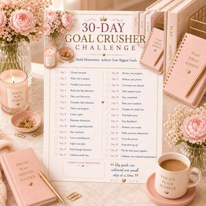 May include: A 30-Day Goal Crusher Challenge paper tracker with gold text and a list of daily tasks. The sheet features a section for reflection and the quote, Big goals are achieved one small step at a time. It is surrounded by pink notebooks, a mug, and flowers.