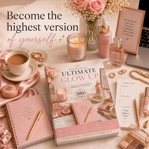 May include: A pink-themed flat lay arrangement with a journal, candles, perfume, and makeup. A cup of tea and a framed quote are also present. The journal has the text "Focus, Discipline, Consistency, Success".