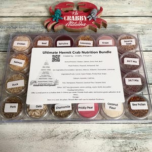 May include: A clear plastic container filled with small, labeled jars of hermit crab food. The labels include ingredients like chicken, spirulina, and chamomile. A red crab-shaped decoration sits above the container, with the words "No Crabby Attitudes".