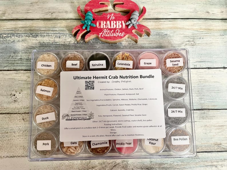 May include: A clear plastic container filled with small, labeled jars of hermit crab food. The labels include "Chicken," "Beef," "Spirulina," and more. A sign reads "Ultimate Hermit Crab Nutrition Bundle."