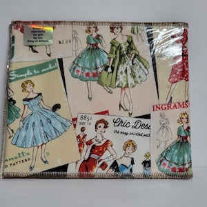 May include: A fabric item featuring a vintage dress pattern design. The pattern includes illustrations of women in dresses, with text that reads "Simple to make!" and "Chic Designs." The item has a sewn edge.