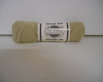 May include: A skein of beige tapestry wool yarn labeled "Elsa Williams NeedleArt Collection" and "Needlepoint Yarn".