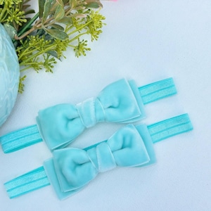 Headband for newborns 0 to 3 months old with a teal, pink salmon, or a fuchsia pink velvet bow.