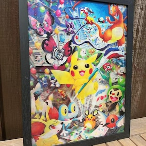 May include: Framed artwork featuring a vibrant collage of colorful cartoon characters, including a yellow Pikachu, butterflies, and other creatures. The artwork is set against a backdrop of a cityscape and balloons, all within a black frame.