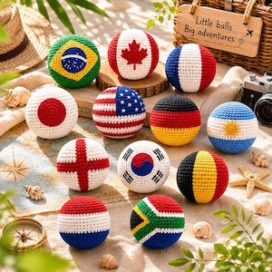 May include: A collection of crocheted balls, each designed to resemble a national flag. Flags include Brazil, Canada, France, Japan, the United States, Germany, Argentina, England, South Korea, Belgium, and South Africa. The text "Little balls Big adventures" is visible.