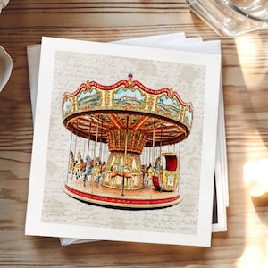 May include: A vintage-style carousel illustration with horses, a red and gold canopy, and a red base. The carousel is set against a backdrop of faded script, evoking a nostalgic, antique aesthetic. The image is printed on a square card.