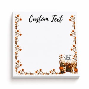 May include: A square notepad with a white background featuring a border of orange and brown autumn leaves. The text Custom Text appears at the top. In the bottom right corner, there is an illustration of three snowmen with books and pumpkins.