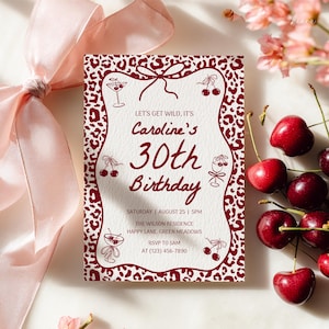May include: A maroon and white invitation card for a 30th birthday celebration. The card features a leopard print border and decorative cherry and cocktail illustrations. The text reads "Caroline's 30th Birthday" with event details.