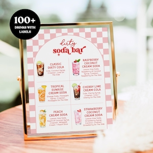 May include: A framed sign with a gold border displays a "Dirty Soda Bar" menu. The menu features six colorful soda drinks with labels, including Classic Dirty Cola, Raspberry Coconut Cream Soda, and Strawberry Coconut Cream Soda. The sign reads "100+ Drinks With Labels."