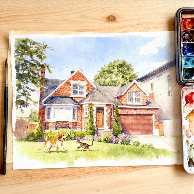 May include: Watercolour painting of a brick house with a brown garage door, a green lawn, and a blue sky. A dog and a cat are playing on the lawn. A paintbrush and a watercolour palette are on the wooden surface.