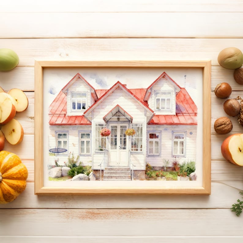 May include: A framed watercolour painting of a white house with a red roof. The house features multiple windows and a porch with hanging flower baskets. Apples, nuts, and a pumpkin are arranged around the frame, on a wooden surface.