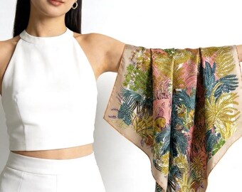 May include: A square silk scarf featuring a detailed botanical print with shades of olive green, teal, and soft pink on a beige background. The scarf displays intricate illustrations of tropical foliage, ferns, and palm leaves with a solid border.