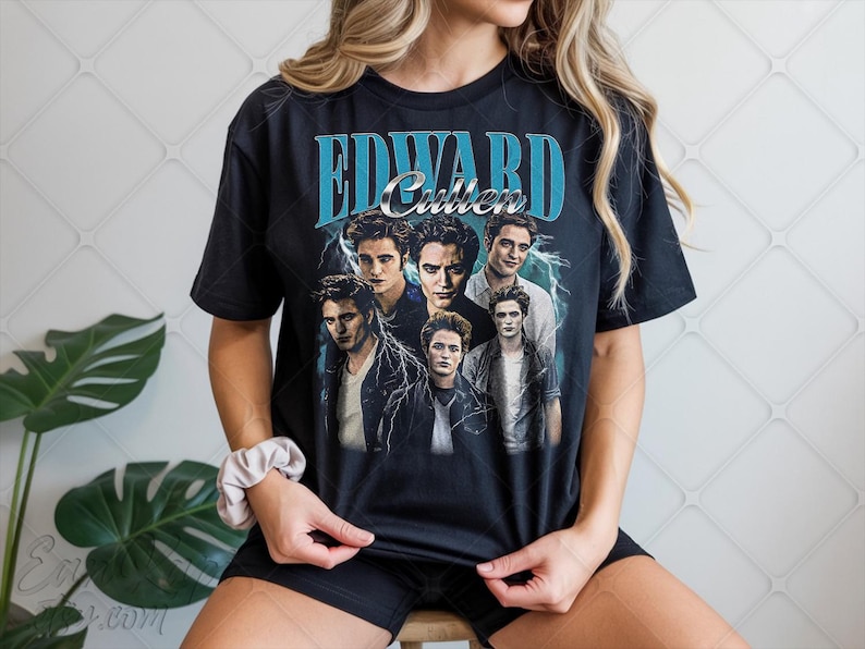 May include: Black t-shirt featuring a graphic of Edward Cullen and other characters from the Twilight saga. The design includes the name "Edward Cullen" in a blue, vintage-style font, with a lightning bolt effect.