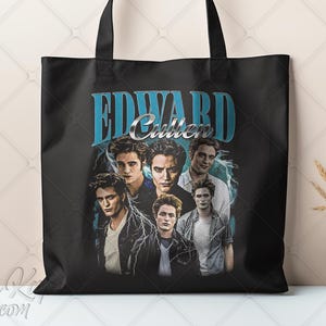 May include: Black tote bag featuring a collage of images of Edward Cullen with the text "EDWARD Cullen" in a blue and silver design. The bag has black handles and a white background.