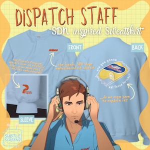 May include: Pale blue "SDN inspired Sweatshirt" with front and back graphics. The front has the SDN logo, and the back shows a Twinkies graphic with text. The sleeve has a Phoenix Program logo. Text reads "DISPATCH STAFF".