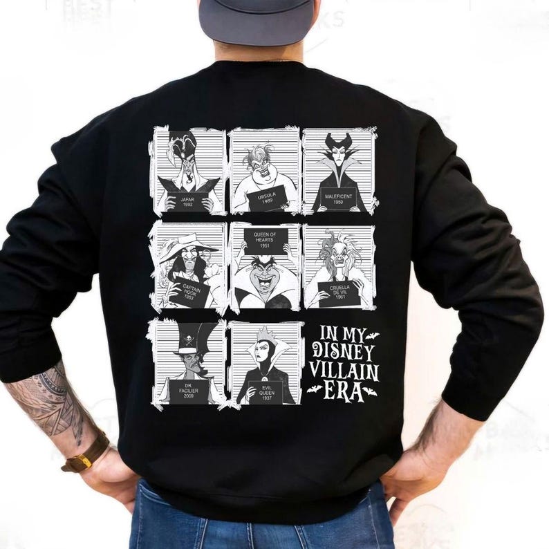 May include: Black sweatshirt featuring a grid of Disney villains in mugshot style. Each villain holds a sign with their name and year. The text "IN MY DISNEY VILLAIN ERA" is printed below the grid in white.