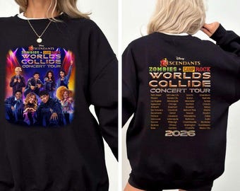 May include: A black long-sleeve sweatshirt featuring a graphic print of the Disney Descendants Zombies + Camp Rock Worlds Collide Concert Tour. The front displays a cast photo under stage lights, while the back lists tour cities and the year 2026.