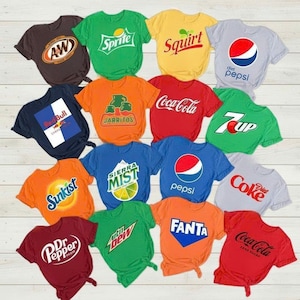 May include: A collection of colorful t-shirts featuring logos of popular soft drink brands. Shirts include Coca-Cola, Pepsi, Sprite, Fanta, and others. The shirts are in various colors, including red, blue, green, and orange.