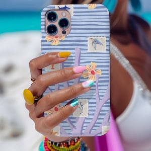 May include: A phone case with a blue and white striped pattern, featuring floral and stamp-like designs. The case has a light blue background with horizontal stripes. The design includes yellow flowers and postage stamp illustrations.