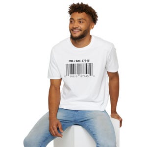 May include: White t-shirt with a black barcode design and the text "ITM. / ART. 87745". The shirt is worn by a person in blue jeans. The barcode has the numbers "0 96619 87745 4" below it.