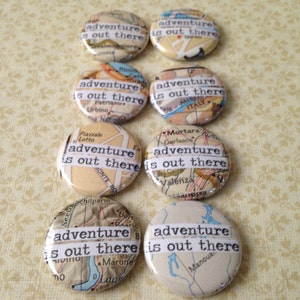 May include: Set of eight round button pins with a vintage map background and the text "adventure is out there" printed in white on each pin.